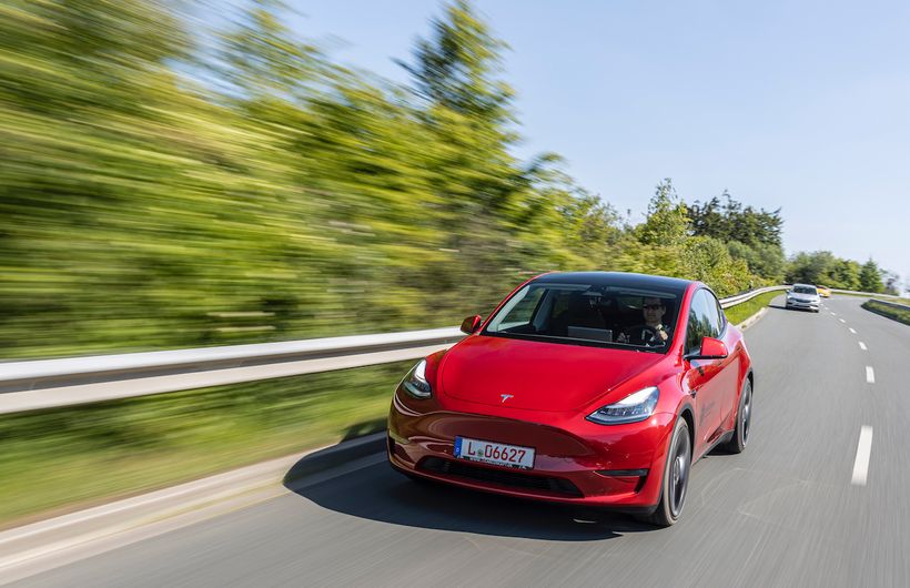 Red Tesla Model Y driving front